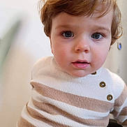 Amaury participe au concours pour gagner de l'argent avec cette photo : baby, blue_eyes, brown_hair, buttons, child, closeup, curious, cute, expression, face, head_and_shoulders, indoor, person, portrait, soft_light, striped_clothing, sweater, toddler, warm_colors, young_child