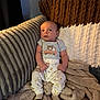 Bryson is registered to the contest to win money with this photo: baby, infant, pajamas, blanket, couch, plush, soft, cozy, child, person, sitting, indoors, cute, sleepwear, warm, comfortable, young, face, head, expression