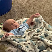 Bryson joined the competition — help win amazing prizes! baby, sleeping, blanket, cushion, carpet, infant, face, arm, clothing, pattern, animal_print, comfort, rest, child, indoor, soft, cute, peaceful, person, toddler
