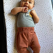 Bryson joined the competition — help win amazing prizes! baby, barefoot, blanket, child, clothing, cute, face, foot, grey_shirt, hand, happy, head, indoors, infant, lying_down, pants, portrait, skin, smiling, star_pattern