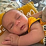Bryson is registered to the contest to win money with this photo: baby, sleeping, infant, arm, yellow_clothing, blanket, indoor, baby_rocker, peaceful, closeup, child, soft_texture, skin, hand, rest, nap, comfort, portrait, casual, relaxation
