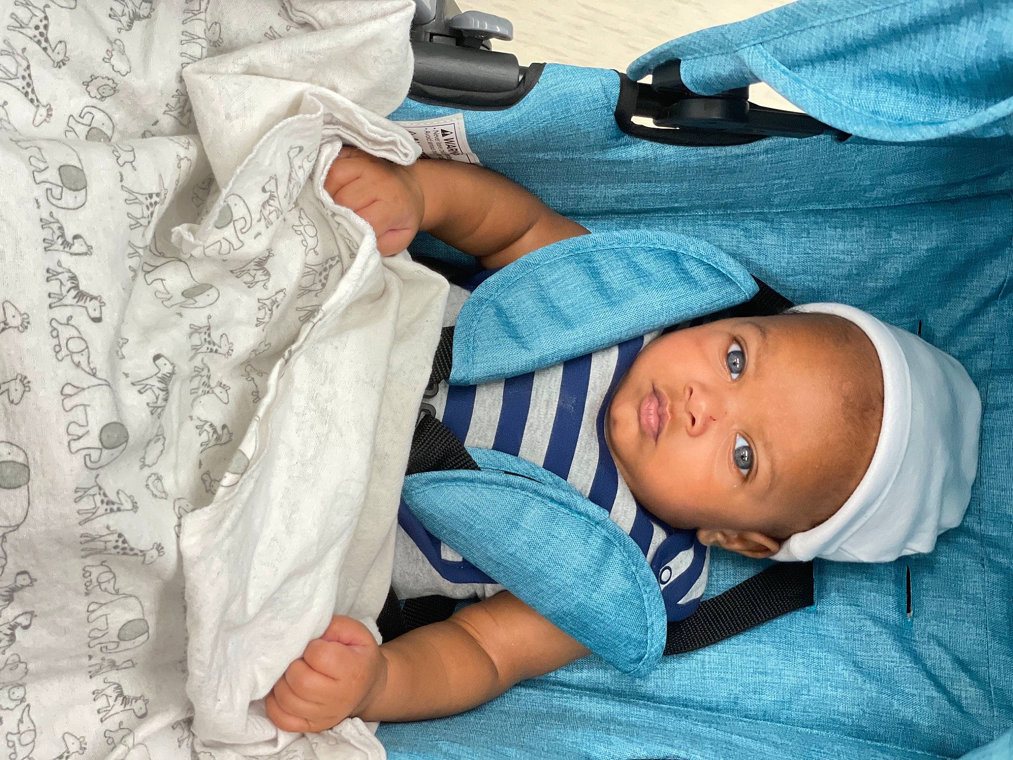 Mazakai is registered to the contest to win money with this photo: baby, baby_products, baby_toddler_clothing, blue, child, comfort, elbow, finger, hand, hat, joint, linens, person, room, skin, sleeve, smile, t_shirt, textile, toddler