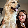 dog, woman, indoor, smiling, happy, pet, fur, tongue_out, face, portrait, casual, cuddling, long_hair, light_skin, seated, clothing, home, friendly, companion, relaxed
