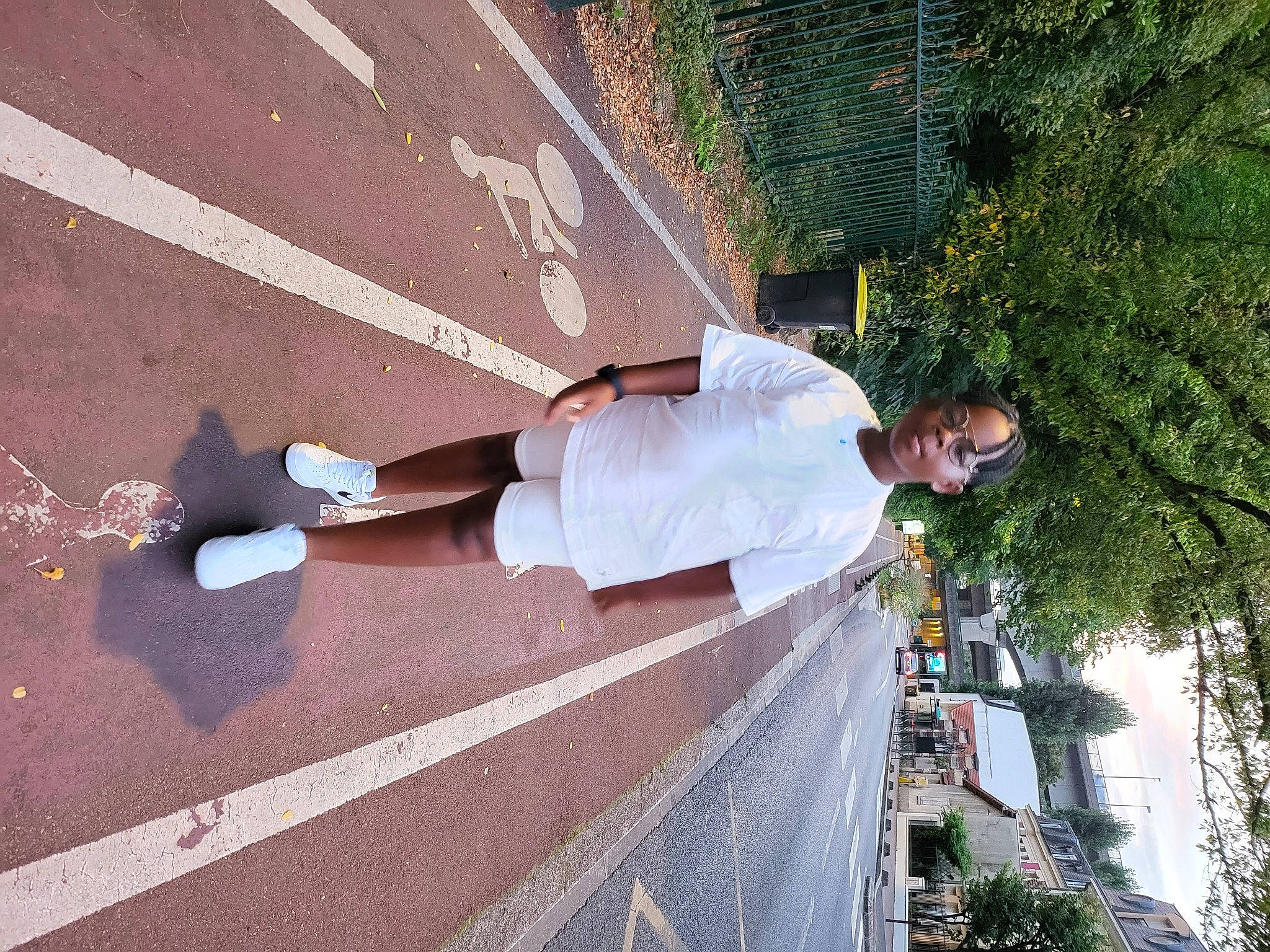 Gabriel participe au concours pour gagner de l'argent avec cette photo : asphalt, concrete, fun, human_leg, knee, leg, leisure, morning, pedestrian, person, plant, public_space, recreation, road, road_surface, shadow, sidewalk, sneakers, thigh, tree