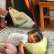 Zunairah is registered to the contest to win money with this photo: carpet, chair, child, clothing, cute, expression, floor, furniture, hair, home, indoor, patterned, person, pillow, plush, relaxed, resting, toddler, toy, young_child