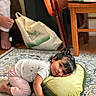carpet, chair, child, clothing, cute, expression, floor, furniture, hair, home, indoor, patterned, person, pillow, plush, relaxed, resting, toddler, toy, young_child