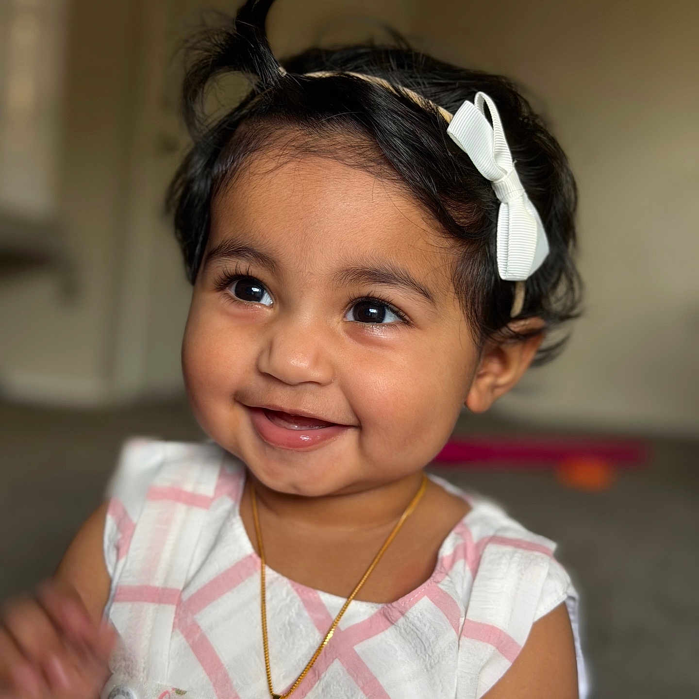 Zunairah joined the competition — help win amazing prizes! baby, black_hair, bow, cheeks, closeup, cute, dark_eyes, dress, eyes, happy, headband, indoor, infant, mouth, necklace, playing, portrait, skin, smile, toddler