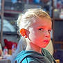 Louis participe au concours pour gagner de l'argent avec cette photo : child, face, blonde_hair, hoodie, indoor, portrait, serious_expression, young, person, sitting, casual_clothing, warm_light, focused, human, childhood, cute, soft_background, skin, head, eyebrows