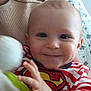 Louis participe au concours pour gagner de l'argent avec cette photo : baby, smiling, superman_logo, striped_clothing, indoor, toy, hand, person, red_nails, face, child, holding, furniture, door, quilt, happy, closeup, caucasian, infant, playful