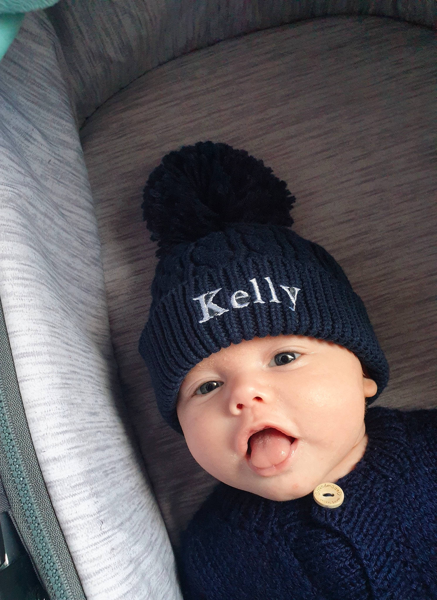 Kelly joined the competition — help win amazing prizes! baby, baby_toddler_clothing, beanie, bonnet, cap, cheek, child, comfort, fashion_accessory, grey, headgear, headwear, knit_cap, outerwear, pattern, person, sleeve, textile, toddler, winter
