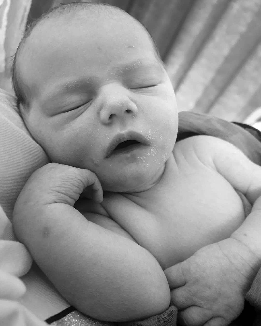 Kelly is registered to the contest to win money with this photo: arm, baby, black, cheek, comfort, eye, eyebrow, finger, gesture, hand, happy, human_body, iris, lip, mouth, nose, person, photograph, skin, toddler