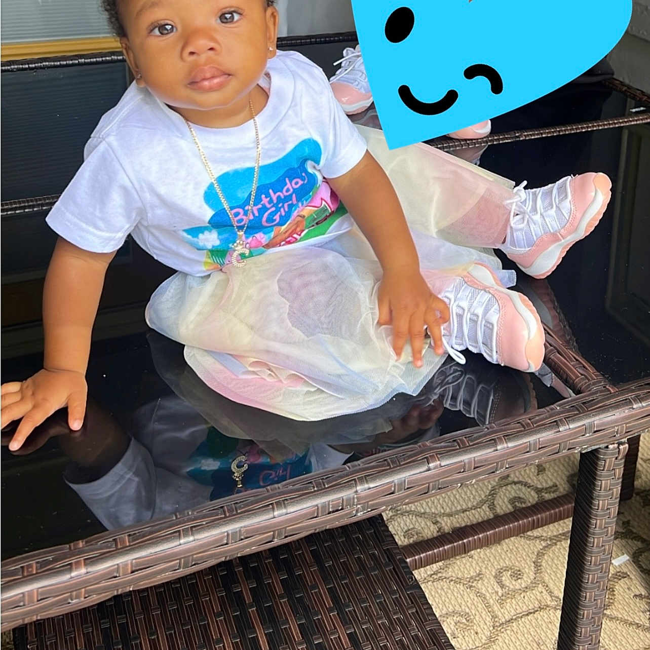 Chosen is registered to the contest to win money with this photo: baby, bodypart, clothing, dress, face, finger, footwear, furniture, hand, head, pants, person, photography, portrait, sandal, shoe, sitting, sneaker, t_shirt, table
