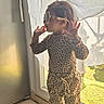 toddler, child, sunglasses, leopard_print, standing, window, sunlight, curtain, bracelet, fashion, indoors, pose, footwear, tile_floor, casual, person, young_child, cute, accessories, playful