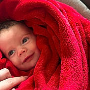 Billy is registered to the contest to win money with this photo: baby, blanket, red, soft, face, hand, smile, child, infant, cozy, warm, wrapped, cute, portrait, skin, expression, comfort, fingers, closeup, toddler