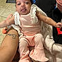 Cherish joined the competition — help win amazing prizes! baby, infant, pink_clothing, frills, blanket, person, skin, tattoo, floor, diapers, indoor, carpet, cute, smile, tongue_out, arm, hand, home, relaxing, casual