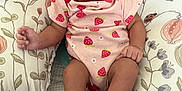 Cherish is registered to the contest to win money with this photo: baby, infant, child, smiling, onesie, hair_bow, pillow, floral_pattern, cute, tongue_out, relaxed, indoor, soft_toy_support, pink_clothing, legs, feet, hand, person, happy, closeup