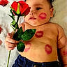 baby, infant, child, portrait, lying_down, bed, rose, flower, lipstick_kisses, kiss_marks, smiling, face, bare_chest, denim, jeans, red_flower, green_leaves, indoor, bedding, photography