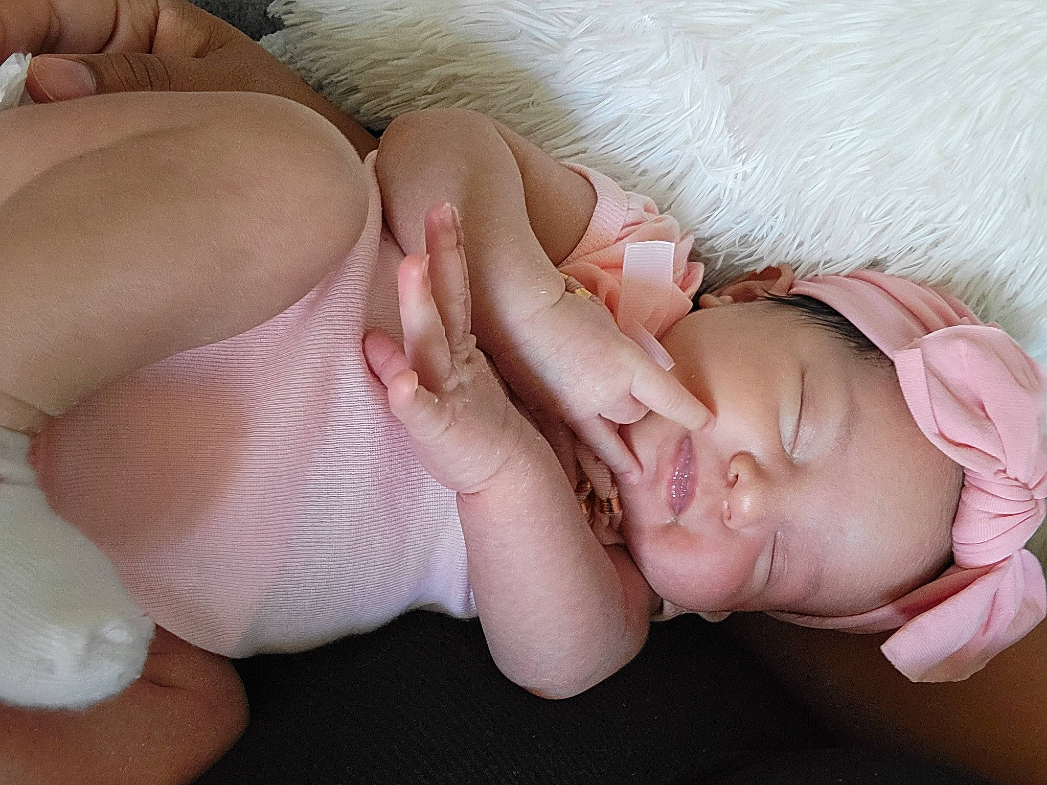 Mariana is registered to the contest to win money with this photo: arm, baby_toddler_clothing, comfort, ear, eyelash, finger, gesture, hand, head, headgear, headwear, human_body, leg, lip, mouth, muscle, nail, neck, person, pink