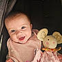 baby, smiling, blue_eyes, pink_bib, plush_toy, mouse_toy, stroller, child, happy, cute, infant, soft_texture, hand, face, head, clothing, comfort, portrait, toy, cozy
