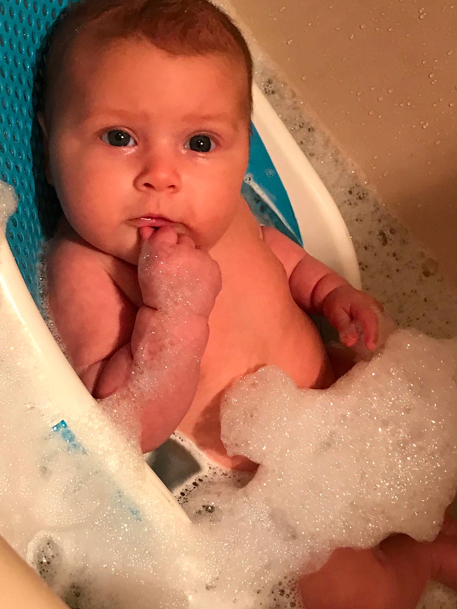 Stella is registered to the contest to win money with this photo: arm, baby, baby_bathing, blue, cheek, chin, ear, eyebrow, eyelash, face, hand, head, human_body, lip, mouth, muscle, neck, nose, person, skin
