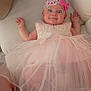 Naomie participe au concours pour gagner de l'argent avec cette photo : baby, infant, pink_dress, headband, bow, lace, pearl, cute, portrait, hands, lying_down, soft_surface, curious_expression, child, clothing, indoors, person, smile, young_child, cute_outfit