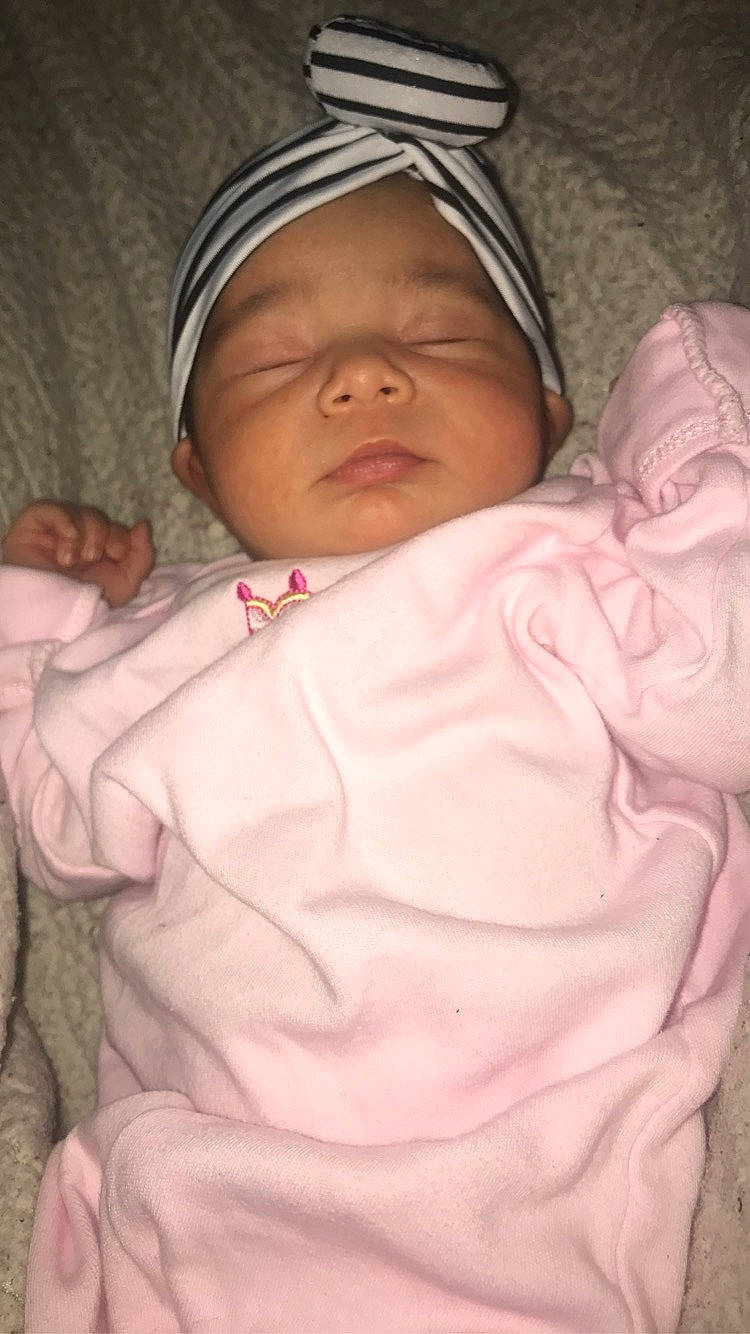 Janel is registered to the contest to win money with this photo: baby, cheek, child, head, headwear, person, pink, skin, smile, toddler