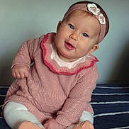 Anava is registered to the contest to win money with this photo: baby, child, infant, portrait, sitting, smiling, happy, face, headband, flower, pink_sweater, knitwear, tights, socks, striped_blanket, indoor, closeup, blue_eyes, baby_fashion, adorable