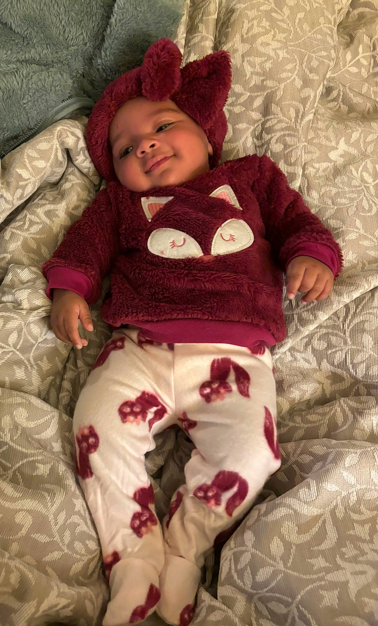 Raelynn is registered to the contest to win money with this photo: baby, baby_toddler_clothing, cheek, child, comfort, eye, face, head, headwear, human_body, linens, magenta, pattern, person, pink, red, skin, sleeve, smile, textile