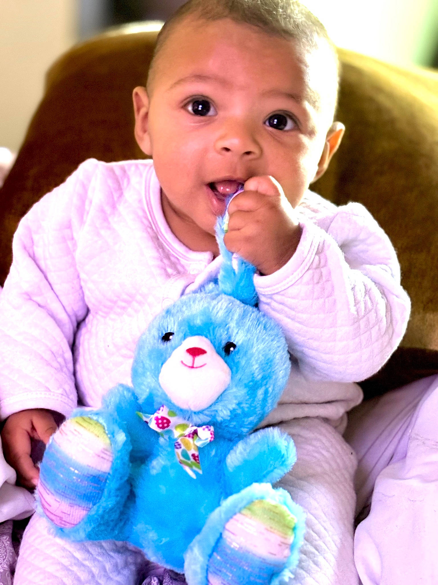 Raelynn is registered to the contest to win money with this photo: azure, baby, baby_toddler_clothing, cheek, finger, gesture, happy, human_body, nose, organ, person, photograph, pink, product, purple, skin, sleeve, stuffed_toy, surprise, toddler