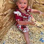 Willow joined the competition — help win amazing prizes! toddler, child, smiling, wood_shavings, play, messy, happy, red_clothing, floral_pattern, shoes, indoors, wooden_wall, fun, cute, young_child, face, arms, legs, sitting, joy