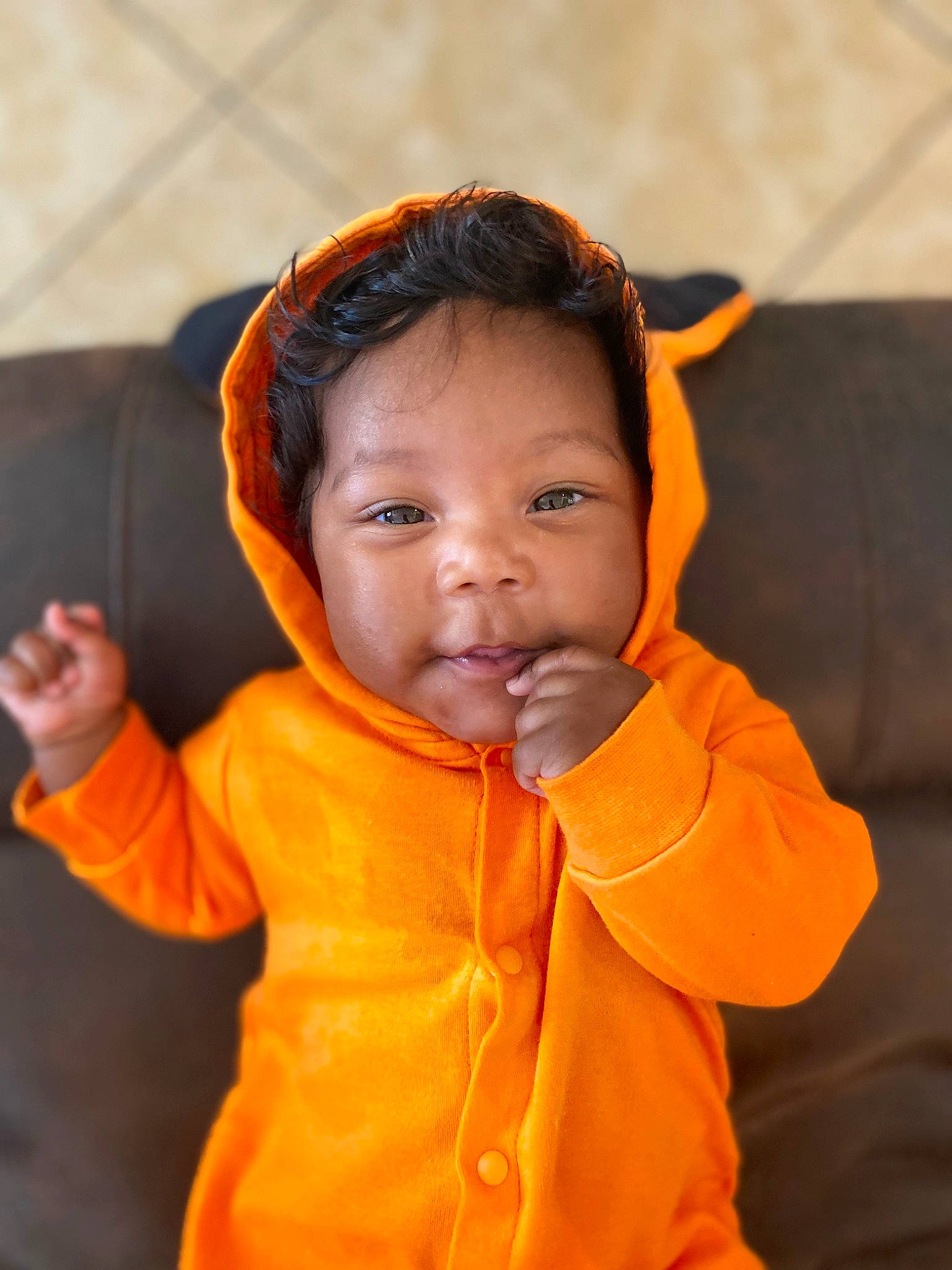 Legacy is registered to the contest to win money with this photo: audio_equipment, cheek, child, comfort, ear, eye, face, fun, gesture, happy, hearing, hoodie, jacket, lifejacket, nose, orange, person, personal_protective_equipment, sleeve, thumb