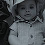 Logan is registered to the contest to win money with this photo: baby, child, hat, shirt, blanket, monochrome, portrait, infant, face, hand, clothing, soft, lying_down, cute, indoor, young_child, calm, relaxed, closeup, baby_clothes