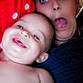 baby, adult, face, smile, laughing, silly_face, selfie, red_background, polka_dots, skin, closeup, expression, joy, happy, indoor, person, child, head, tongue_out, playful