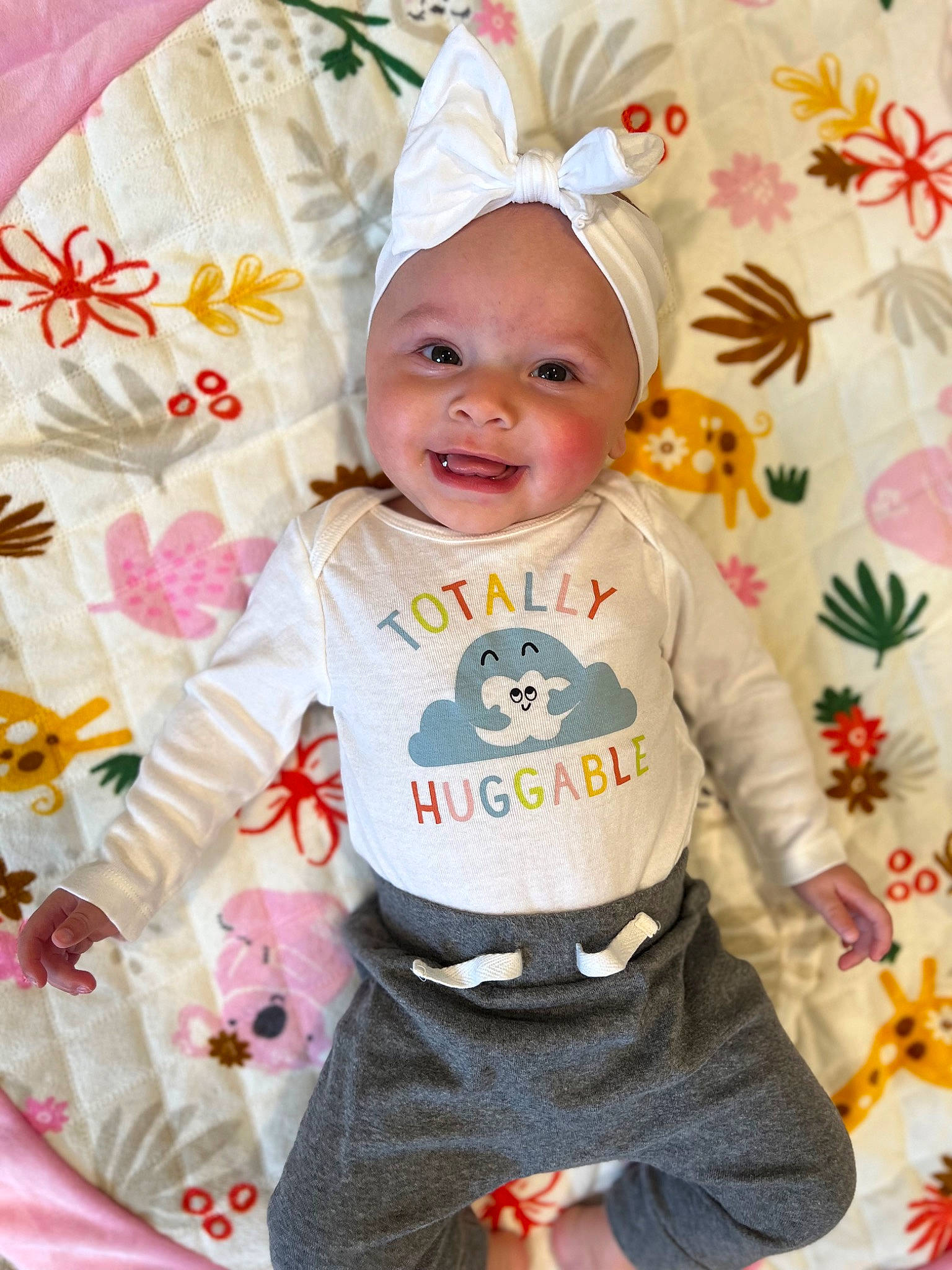 Aubrey is registered to the contest to win money with this photo: baby, baby_products, baby_toddler_clothing, cap, child, event, face, fictional_character, fun, happy, headwear, linens, magenta, pattern, peach, person, pink, sleeve, smile, t_shirt