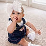 Alora is registered to the contest to win money with this photo: baby, child, infant, girl, denim_dress, white_bow, headband, sitting, carpet, indoor, cute, hand_in_mouth, white_shoes, socks, soft_lighting, window, room, curious, portrait, young