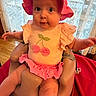 baby, infant, pink_hat, pink_clothing, baby_seat, indoor, curtains, lace, wooden_floor, cherry_design, wide_eyes, cute, child, portrait, person, sitting, clothing, hat, face, looking