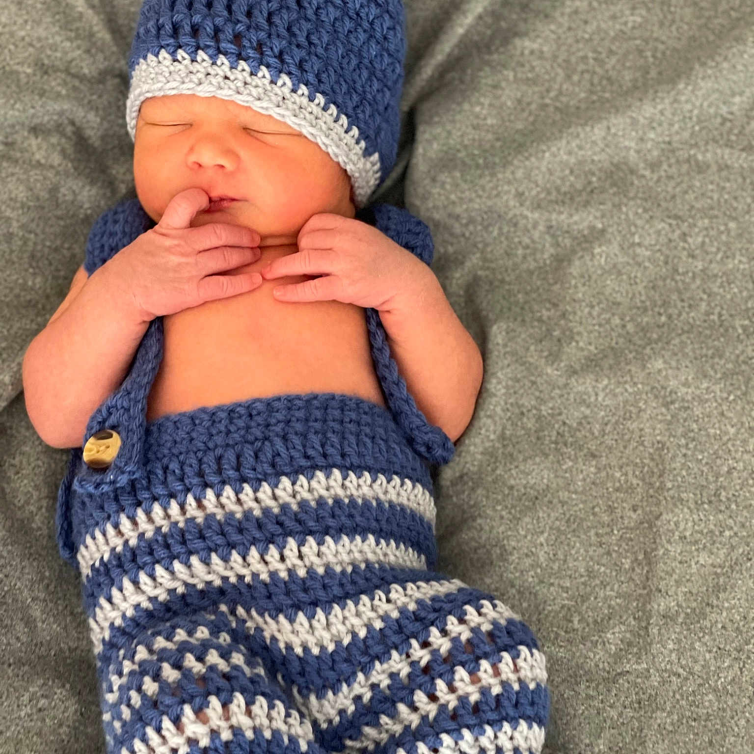Nash is registered to the contest to win money with this photo: arm, azure, baby, baby_sleeping, baby_toddler_clothing, cap, child, comfort, electric_blue, finger, hand, head, headgear, knit_cap, leg, outerwear, sleeve, textile, toddler, woolen