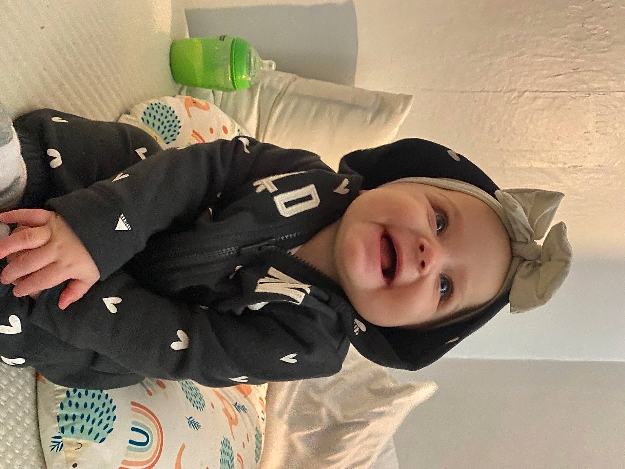 Kylie is registered to the contest to win money with this photo: baby_toddler_clothing, child, comfort, cool, flash_photography, fun, happy, hat, human, joy, knee, outerwear, person, portrait_photography, sitting, sleeve, smile, toddler, tree