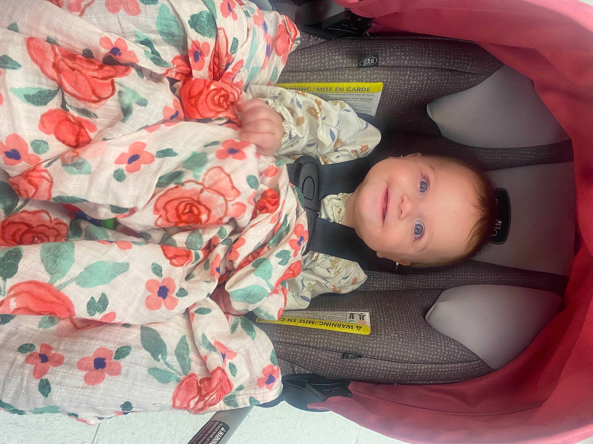 Kylie is registered to the contest to win money with this photo: baby, baby_carriage, baby_products, baby_toddler_clothing, car_seat, carmine, child, comfort, dress, head, human_body, joy, linens, nap, pattern, person, plant, room, sitting, sleeve