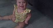Katlieana joined the competition — help win amazing prizes! baby, child, smiling, sitting, yellow_clothing, polka_dots, floor, indoor, cute, happy, person, infant, legs, arms, head, face, eyes, mouth, toes, home