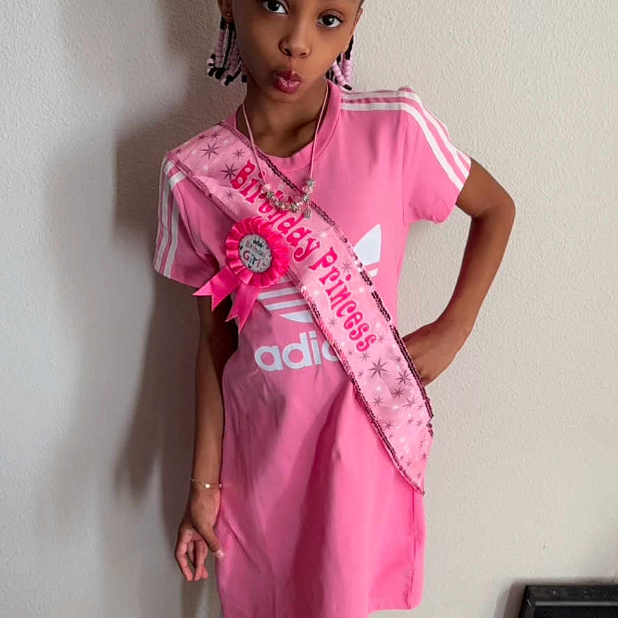 Kalise is registered to the contest to win money with this photo: accessories, birthday_princess, bracelet, carpet, celebration, child, fashion, girl, happy, indoor, jewelry, pink_dress, portrait, pose, sash, sneakers, standing, tiara, wall, white_tights