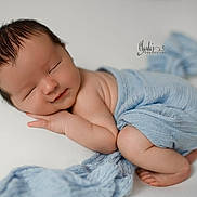 Kooper joined the competition — help win amazing prizes! newborn, baby, sleeping, wrapped, blue_blanket, soft_texture, peaceful, infant, studio_photography, portrait, cute, resting, child, skin, head, hands, feet, closeup, warm_lighting, gentle