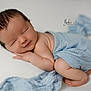 newborn, baby, sleeping, wrapped, blue_blanket, soft_texture, peaceful, infant, studio_photography, portrait, cute, resting, child, skin, head, hands, feet, closeup, warm_lighting, gentle