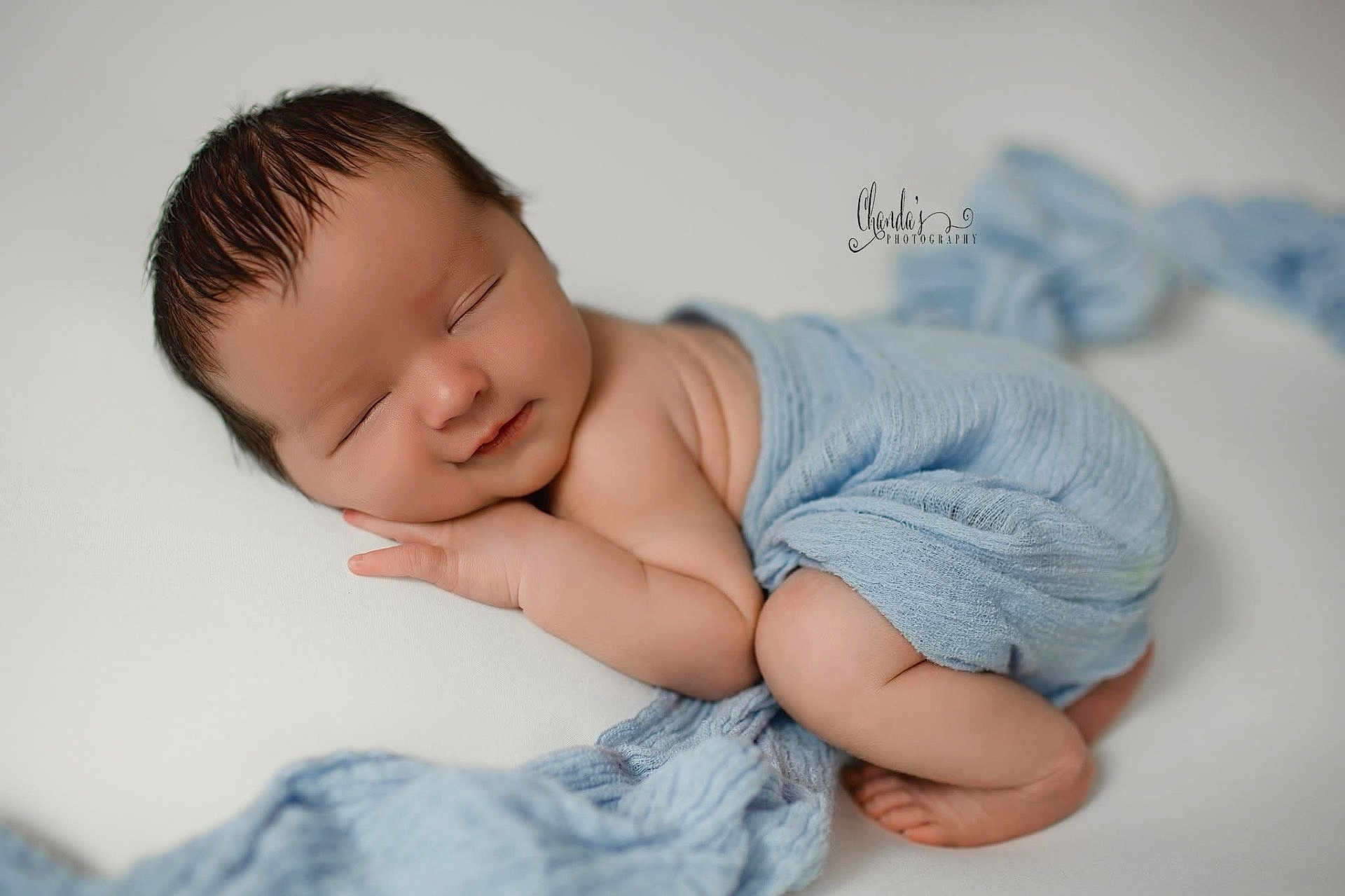 Kooper joined the competition — help win amazing prizes! newborn, baby, sleeping, wrapped, blue_blanket, soft_texture, peaceful, infant, studio_photography, portrait, cute, resting, child, skin, head, hands, feet, closeup, warm_lighting, gentle