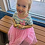 bench, blue_eyes, braided_hair, casual_clothing, child, cookie, cute, daylight, food, girl, happy, indoor, pink_shoes, pink_tutu, portrait, seated, smiling, sprinkles, striped_shirt, window