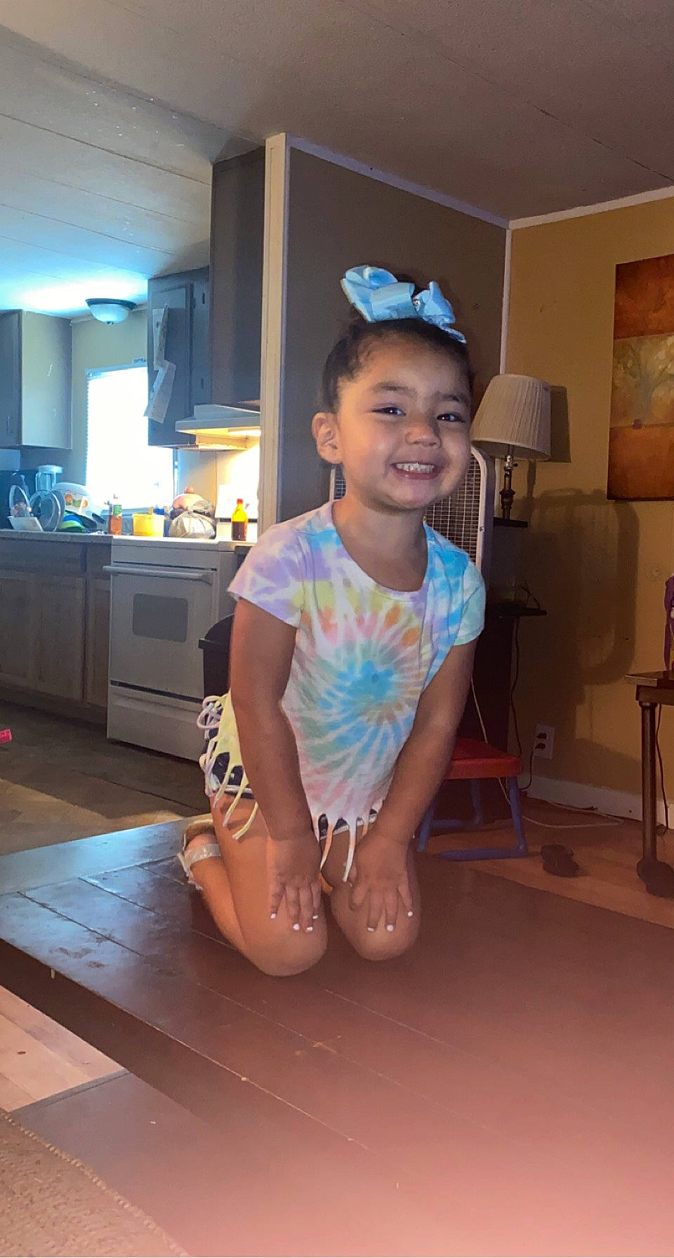 Joyce joined the competition — help win amazing prizes! cabinetry, child, countertop, electric_blue, eyewear, floor, flooring, foot, fun, happy, hat, human_leg, joy, kitchen, kitchen_appliance, knee, person, sitting, smile, t_shirt