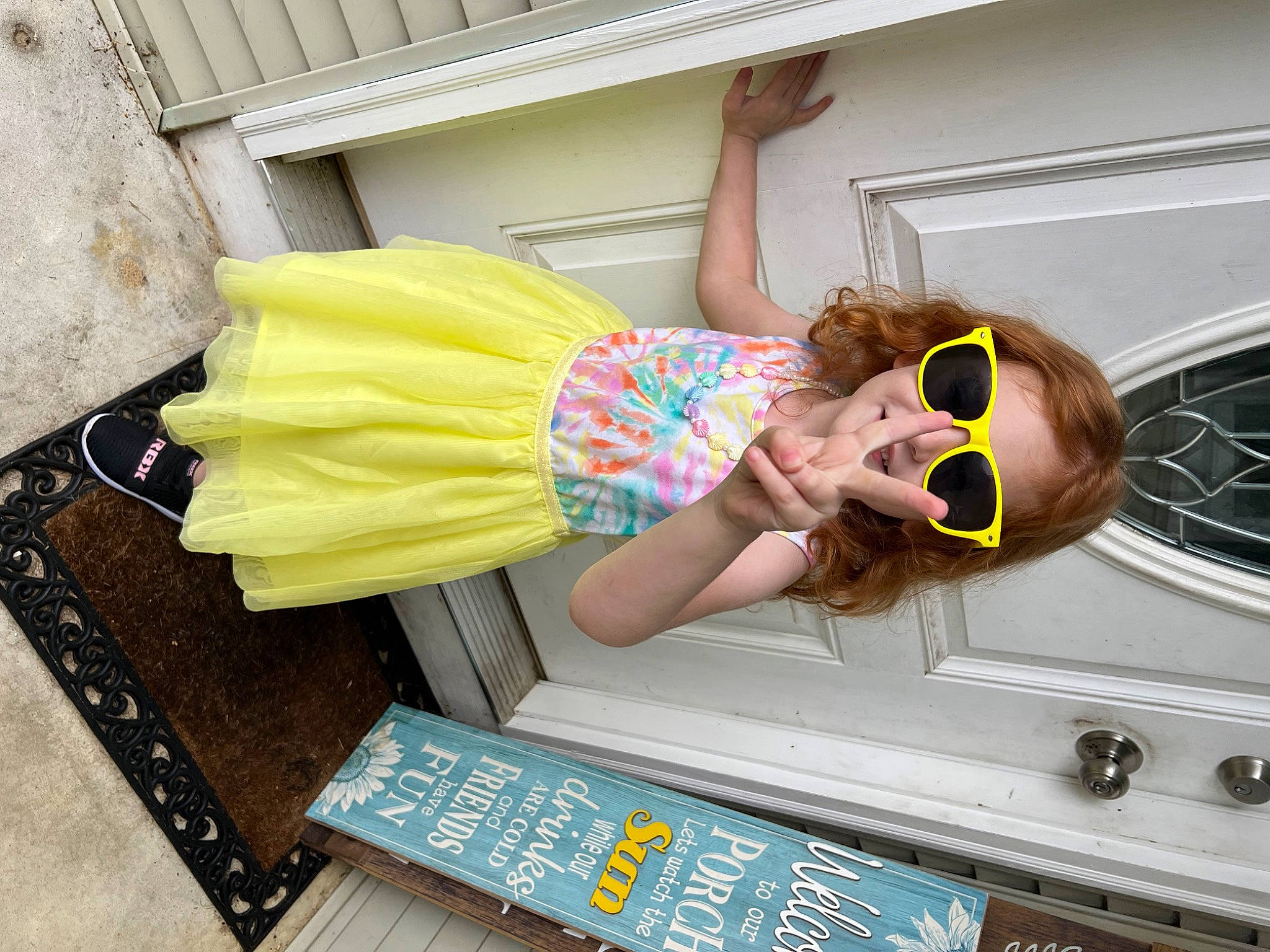 Adelynn is registered to the contest to win money with this photo: abdomen, eyewear, fun, goggles, hat, human_leg, leisure, pattern, person, personal_protective_equipment, room, sandal, sunglasses, thigh, waist, wood, wrist