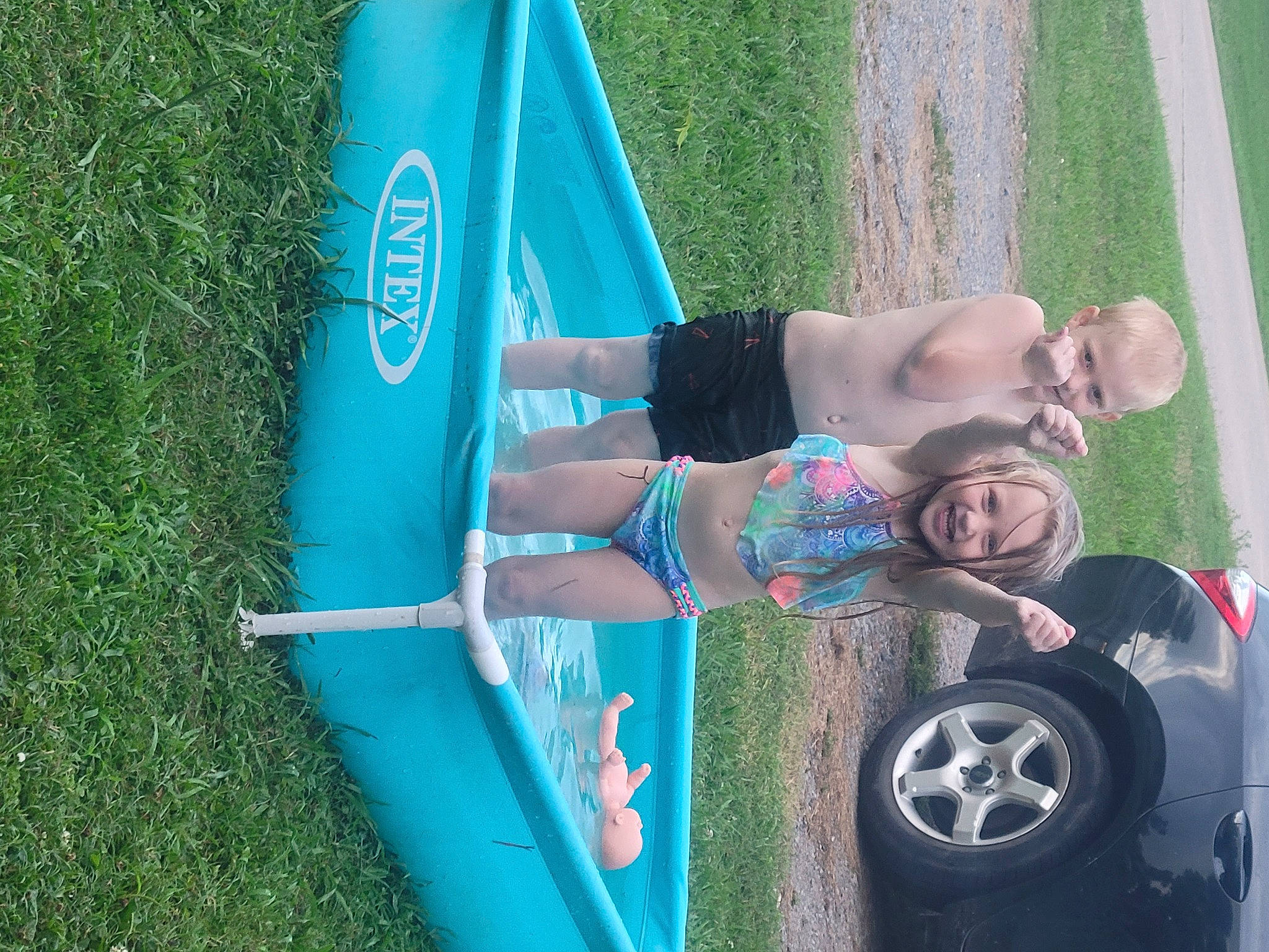 Faith is registered to the contest to win money with this photo: automotive_design, automotive_exterior, automotive_tire, boats_and_boating_equipment_and_supplies, bumper, car, electric_blue, fun, grass, green, human_leg, leisure, motor_vehicle, person, recreation, rim, tire, tree, vehicle, vehicle_door