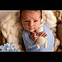 baby, infant, blue_blanket, knitted_toy, bunny, cute, portrait, closeup, soft_texture, cozy, child, wrapped, hands, face, expression, indoors, newborn, plush, warm, rest