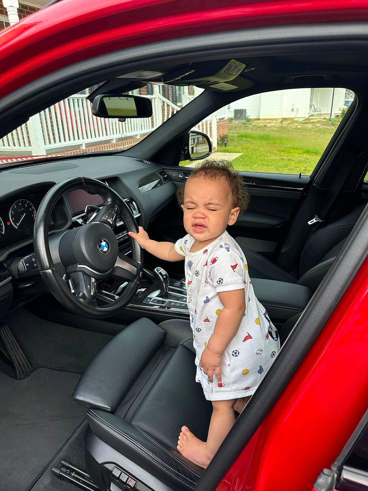 Khalil is registered to the contest to win money with this photo: auto_part, automotive_design, automotive_exterior, automotive_wheel_system, car, car_seat, car_seat_cover, family_car, hood, luxury_vehicle, mid_size_car, motor_vehicle, person, personal_luxury_car, rim, sorrow, steering_part, steering_wheel, tints_and_shades, toddler